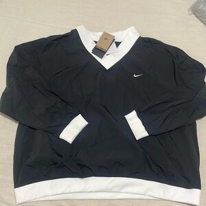 Nike women’s loose UV woven long sleeve V-Neck top.